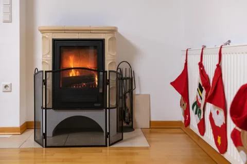Tiled stove with fire burning inside Stock Photos