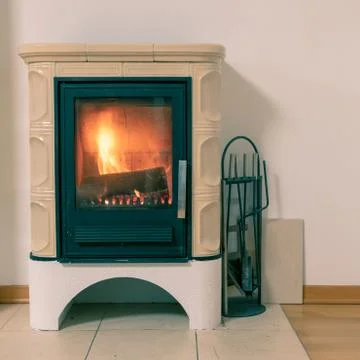 Tiled stove with fire burning inside Stock Photos