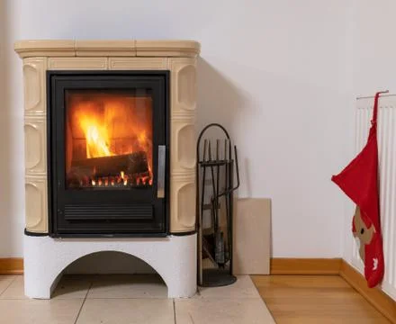 Tiled stove with fire burning inside Stock Photos