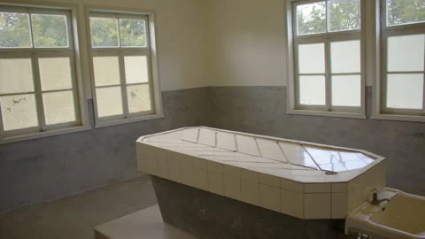 A tiled surgery or autopsy table stands in the middle of a small room 스톡 동영상 299049253