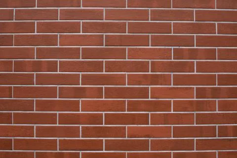 Tiled wall with reddish brown brick appearance and grout finish. Texture for Stock Photos