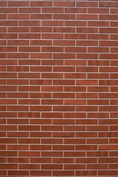 Tiled wall with reddish brown brick appearance and grout finish. Texture for Stock Photos