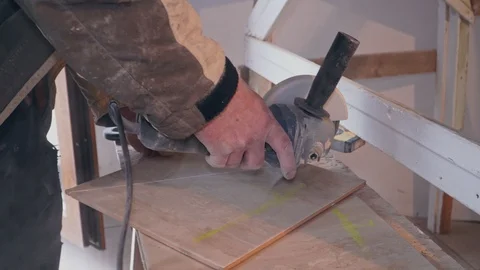 Tiler gently cuts the tile grinder Stock Footage 103473333