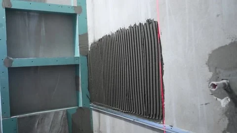 Tiler installing ceramic tile panel in bathroom Stock Footage 91078466