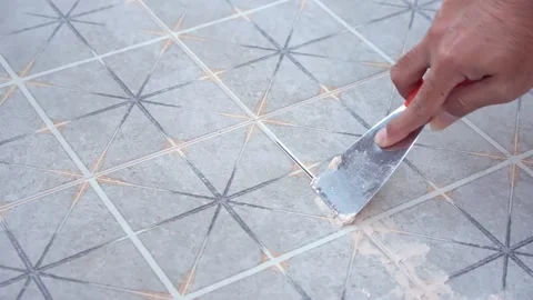 Tiler laying the ceramic tile on the floor. Grouting ceramic tiles Stock Footage 233832400