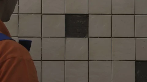 The tiler lays the tiles Stock Footage 112122229