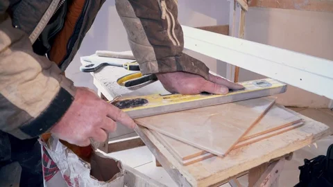 The tiler mixes the cement mortar and lays the tile closeup Stock Footage 103473239