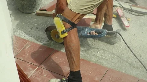 Tiler restoring sidewalk laying of tile in construction Stock Footage 101402634