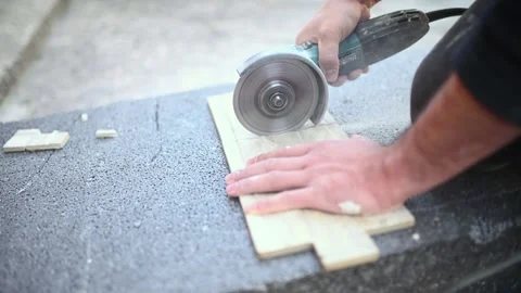 Tiler at work. Closeup of a worker use cutting machine to cut a ceramic tile Stock Footage 243123773
