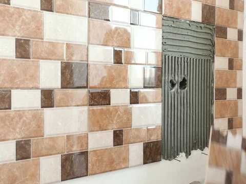 The tiler's hands are installing a tile. Stock Footage 79386935