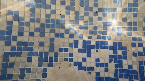 Tiles at the bottom of an old swimming pool illuminated by reflections of l.. Video stock 227159619