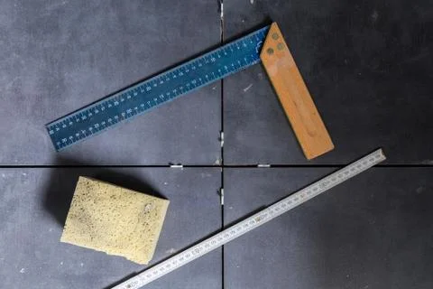 Tiles concept tool, angle, ruler, sponge on tiles top view Stock Photos