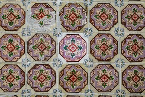 Tiles with different age in Lisbon facade Stock Photos