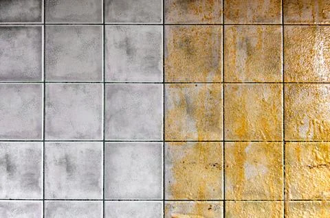 Tiles on the kitchen wall. Tiled wall half clean and half dirty, with a str.. Stock Photos