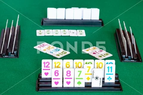Tiles in rack and gameplay in Rummy on table Stock Photos