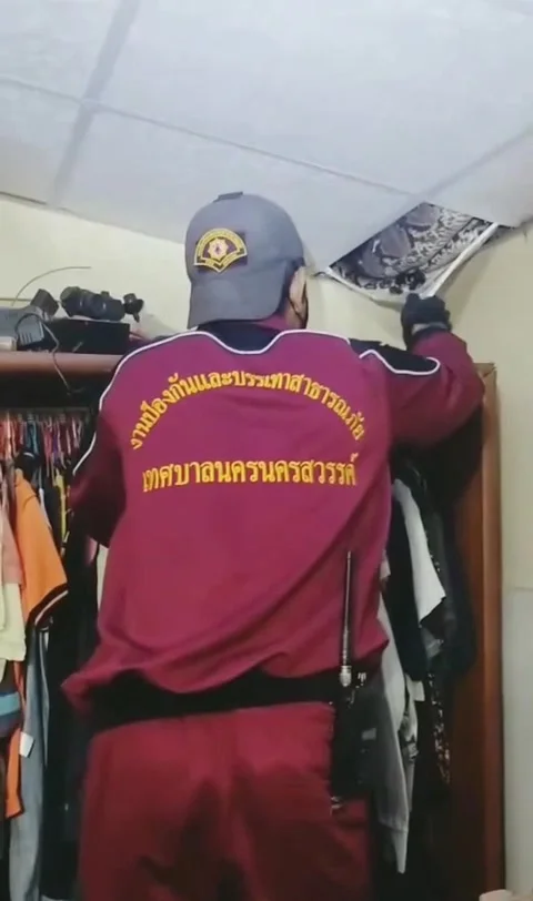 Tiles ripped down as huge python is pulled from ceiling of house in Thailand Stock Footage 273013086