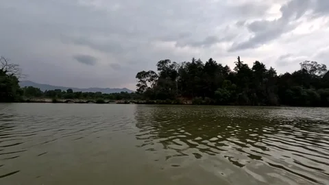 Till down from cloudy sky towards lagoon and travel towards small island Stock Footage 316428675