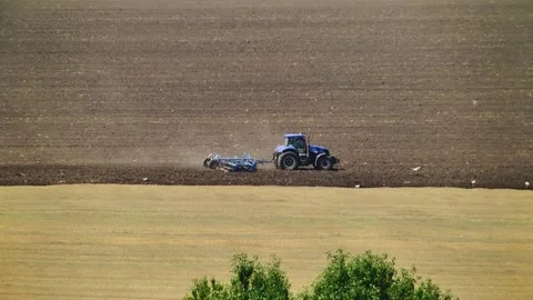 Tillage in the field with a tractor with a machine Stock Footage 147041415