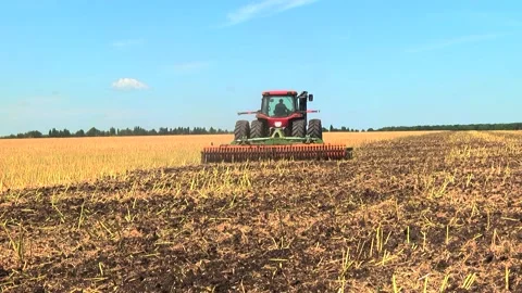 Tillage in the field with a tractor with a machine Stock Footage 147041433