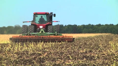 Tillage in the field with a tractor with a machine Stock Footage 147041435
