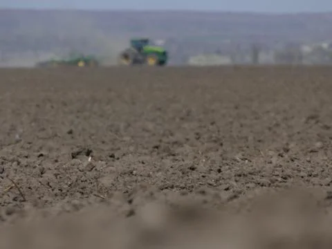 Tillage by tractor. Stock Photos
