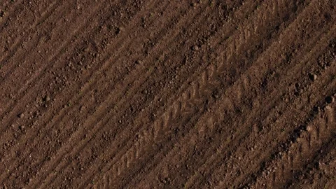 Tilled soil with tractor tire marks in farming field during early spring Stock Footage 311318671