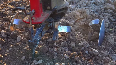 Tilling a garden with a rototiller in the spring. Stock Footage 123788583