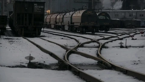 Tilt up across industrial train yard with factories in background Stock Footage 89945281