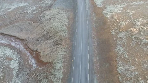 Tilt up aerial top down view 4x4 vehicle drives on on two lane asphalt road t Stock Footage 158170207