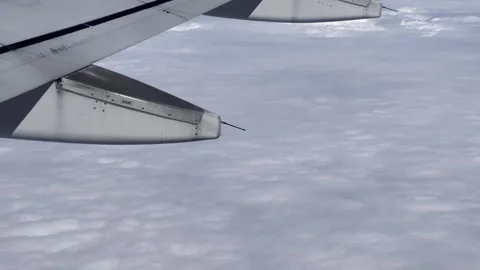 Tilt-up of Airbus A320 wing surface flying high in blue sky Video stock 279407877