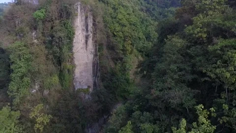 Tilt up and backward movement in a clift and canyon in tropical forest by dr Stock Footage 158598295