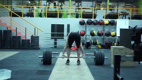 Tilt up and down of strong young aged man lifting barbell Stock Footage 132724475