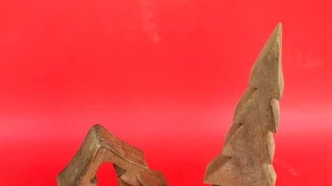 Tilt up and down through two wooden Christmas tree sculptures to copy space on a Stock Footage 70554181