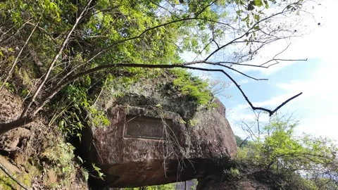 Tilt and pan shot of an ancient mountain pathway with a stone staircase leading Stock Footage 338365355