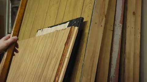 Tilt up and rack focus from carpet to placing set pieces in a flat stack Stock-Footage 89503457