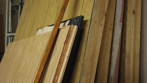 Tilt up and rack focus from carpet to a stack of flats Stock-Footage 89503541