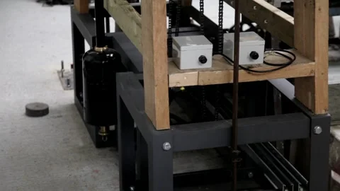 Tilt-Up of Antique Mechanical Turret Clock Movement in Workshop Stock Footage 345755075