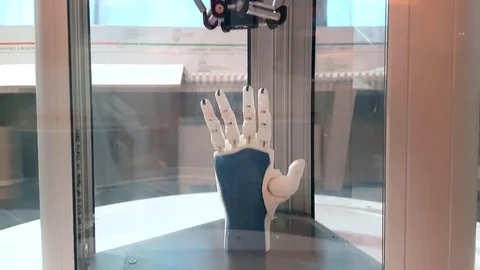 Tilt UP of artificial arm printed on 3D Printer Stock Footage 83702663