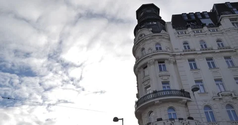 Tilt from a blue sky with clouds down to “Naschmarkt” next to a busy street Stock Footage 106493021