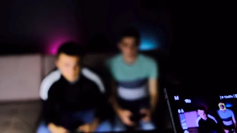 A tilt up camera shot of a camera recording an two young guys are sitting on the Stock Footage 131173904