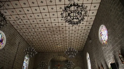 Tilt from ceiling to floor inside the Stone Church with people praying Stock Footage 79460674