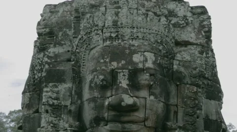 Tilt - close up of statue face - Bayon temple Stock Footage 53136958
