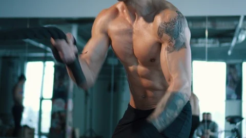 Tilt up to closeup of man's face working out with Battle Ropes Stock Footage 101025077