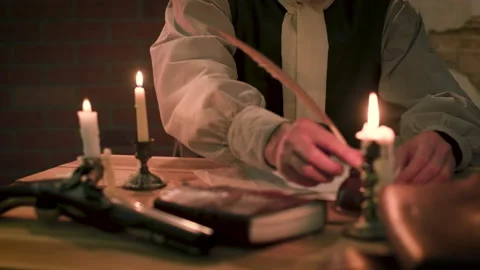 Tilt to colonial man writing a document using a quill pen Video stock 131333590