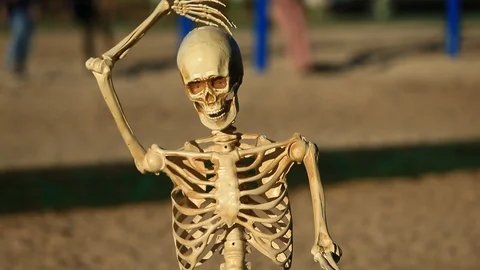 Tilt Up Confused Skeleton doing a Head Scratcher while Playing Chess Stock Footage 97046193