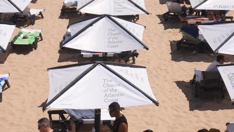Tilt up of crowded sandy Conceicao beach in Cascais near Lisbon, Portugal during Stock Footage 112887125