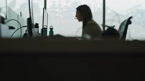 Tilt up to customer service representatives talking and typing in call center / Stock Footage 109573071