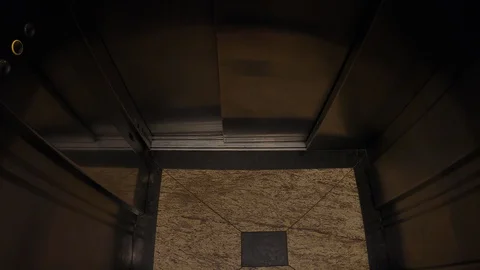 Tilt. Darkness inside the vintage elevator, marble floor, stainless steel wal Stock Footage 124200957