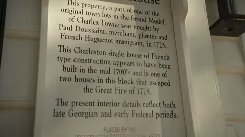Tilt down across sign on the front of Douxsaint House in Charleston Stock Footage 60925512