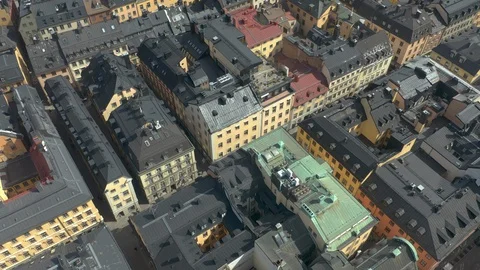 Tilt down aerial view of rooftops &amp; buildings in Old Town, Stockholm City Stock Footage 130144946